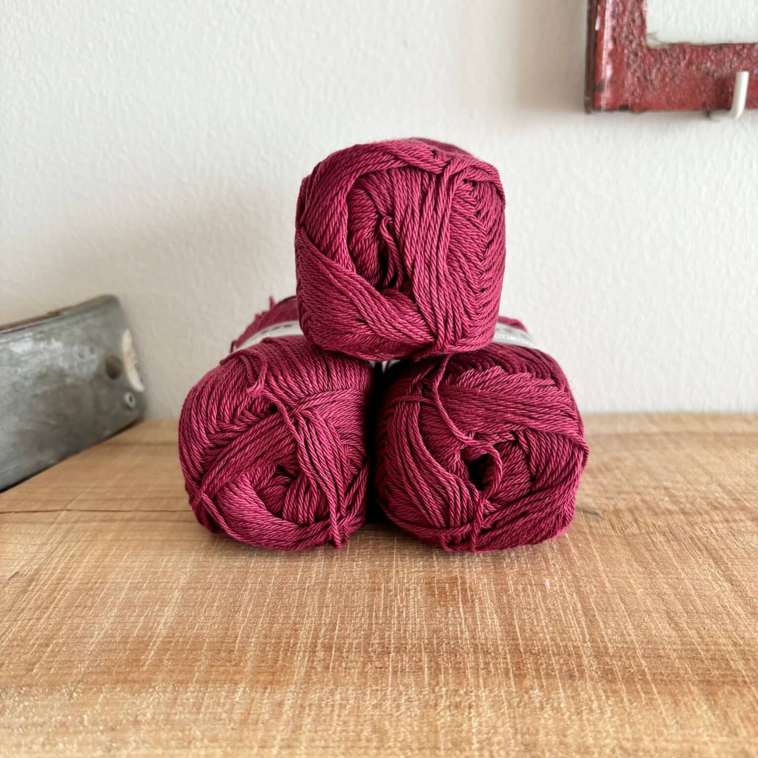 Tre garnnøgler Lammy Cotton 8/4 i vinrød, stablet